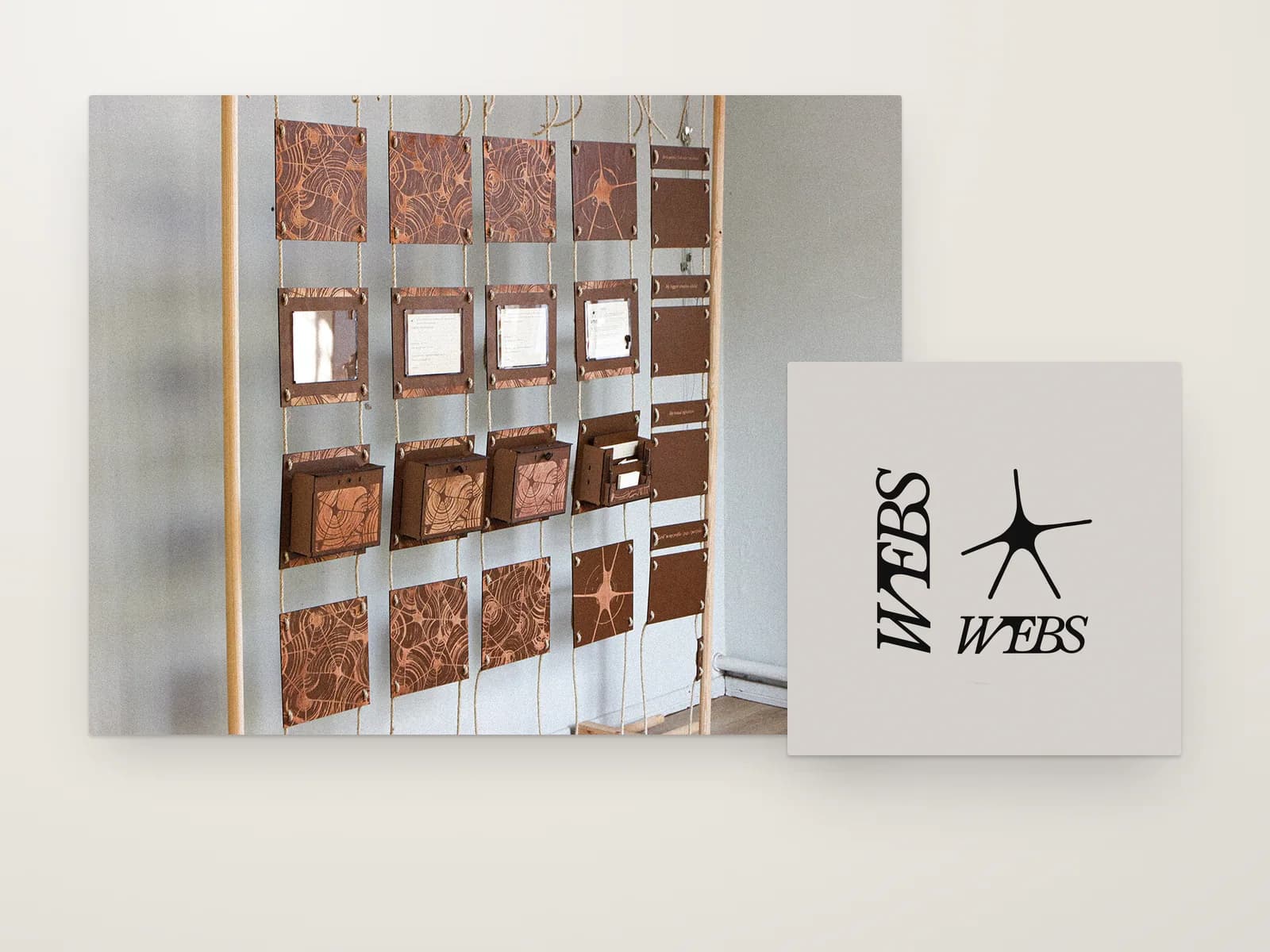 On an off-white wall stage: a photo of the installation, rows of brown laser-cut panels hung on jute rope in a wooden frame, beside a card with the Webs wordmark and its spidery mark.