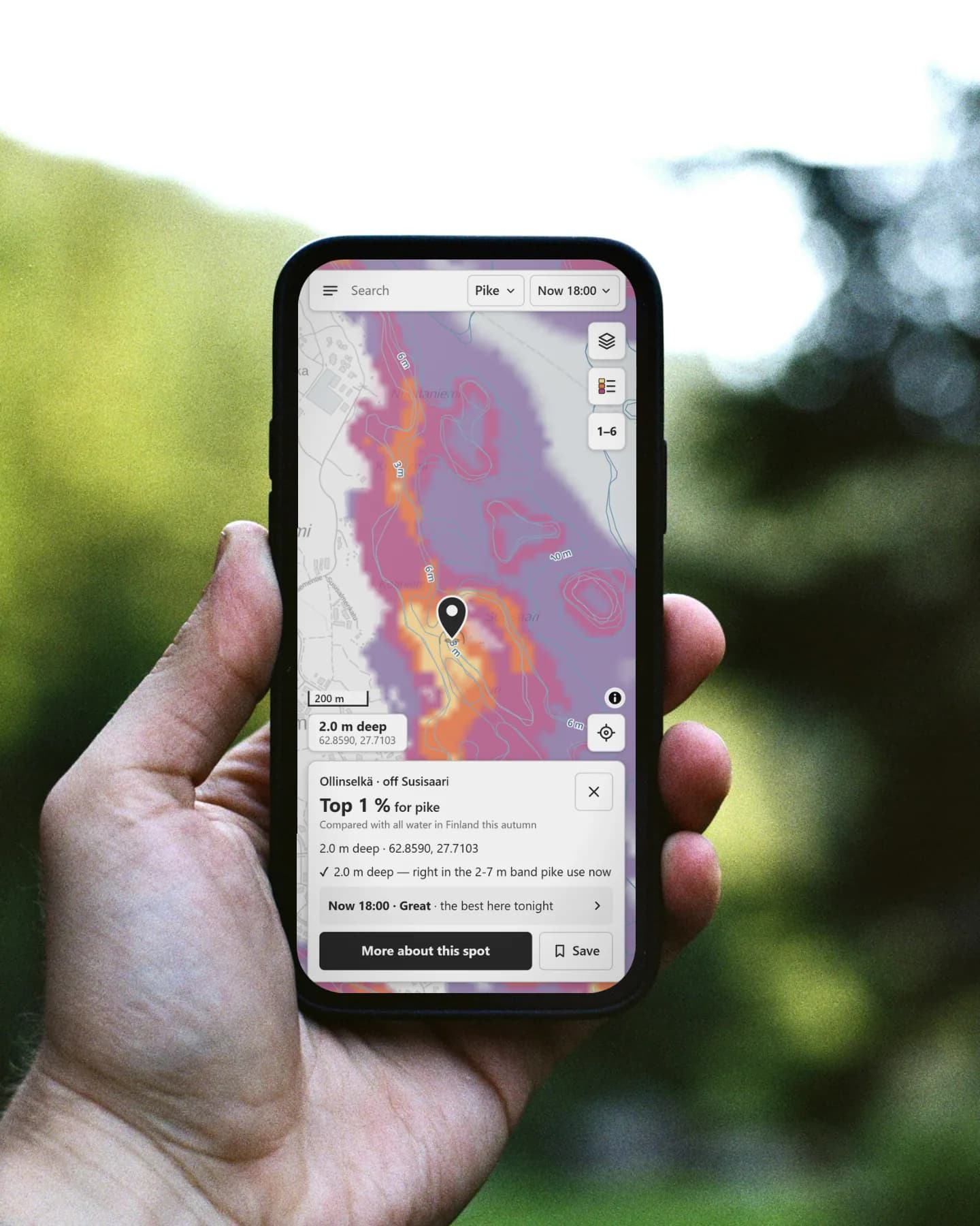 A hand holding a phone outdoors against a blurred green forest. The phone shows the Nappa map with a pin and a spot card: Ollinselkä, off Susisaari, Top 1 % for pike.